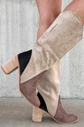 Beige and brown suede boots with block heels on a neutral background