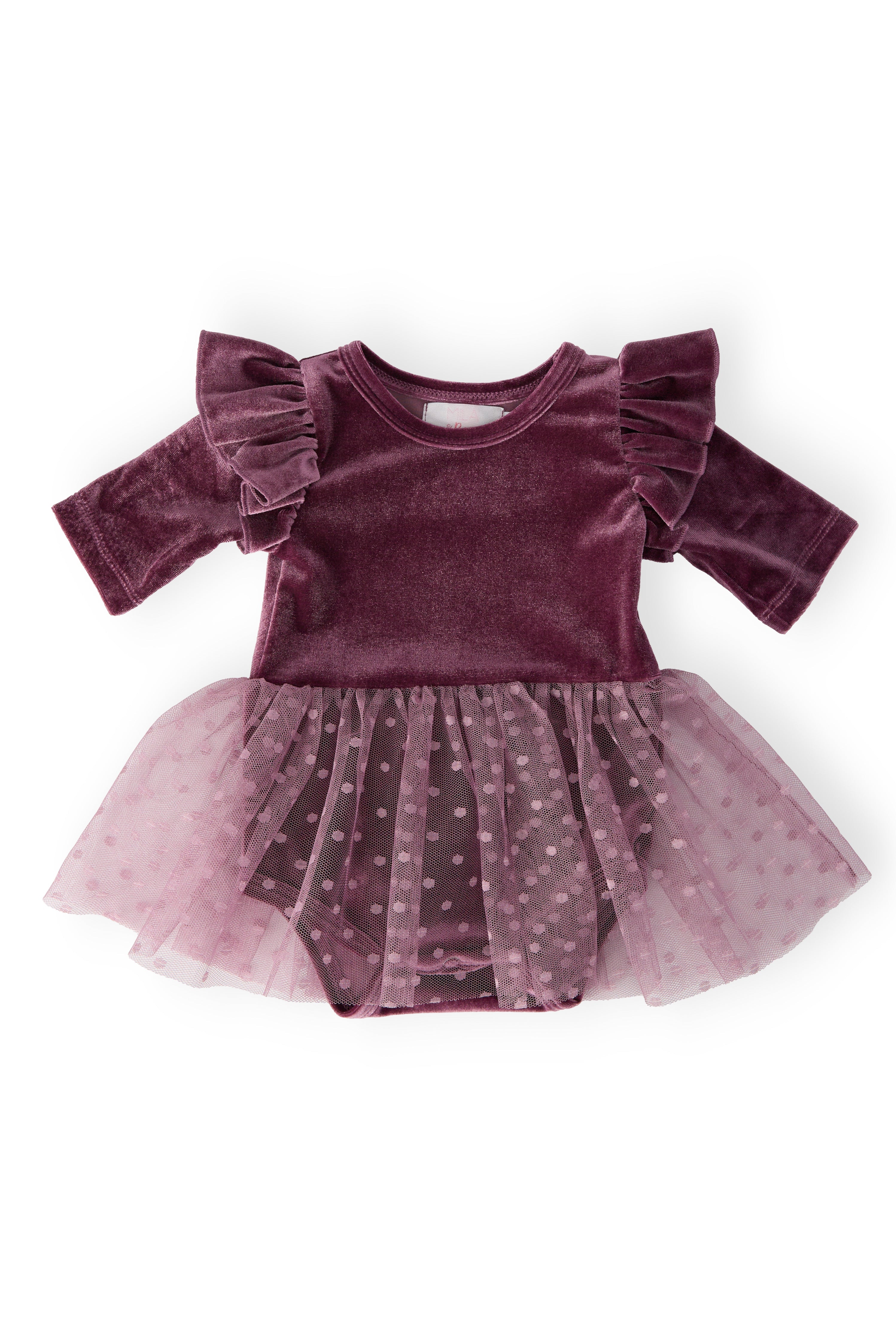 Purple velvet dress with ruffled sleeves and a tulle skirt on a white background