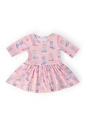 Pink dress with cowboy boot pattern on a white background