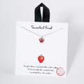 Necklace with strawberry pendant on a branded card