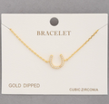 Gold-dipped bracelet with cubic zirconia on a white card